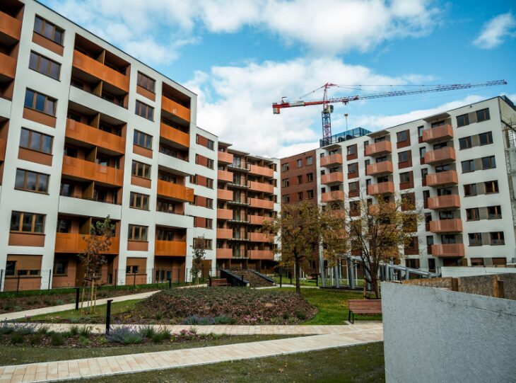 A renter touring an apartment and evaluating unit orientation and noise levels.
