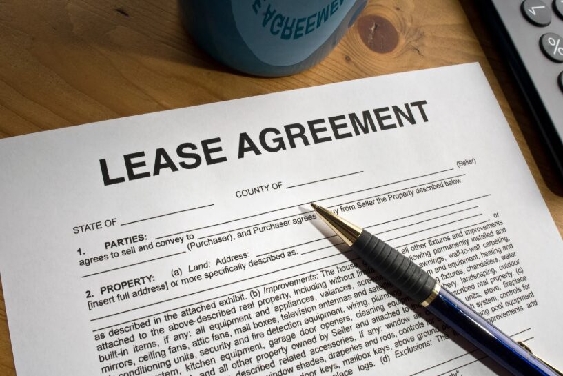 A renter reviewing a furnished apartment lease and inventory list before signing.