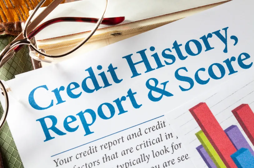 A close-up of a credit report with graphs and glasses, emphasizing the importance of credit history when learning how to get an apartment with bad credit.
