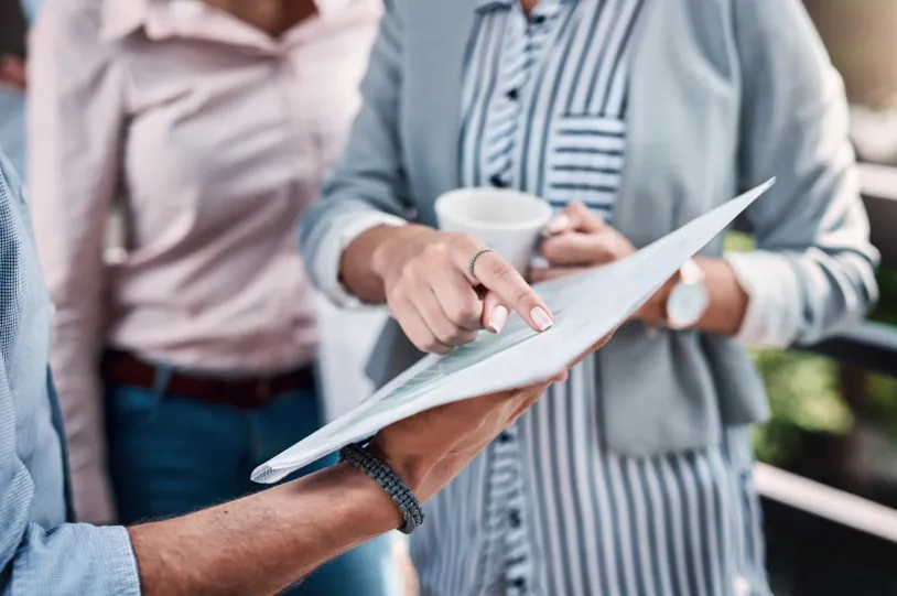 A group of people reviewing a document, discussing terms and strategies for how to get an apartment with bad rental history.