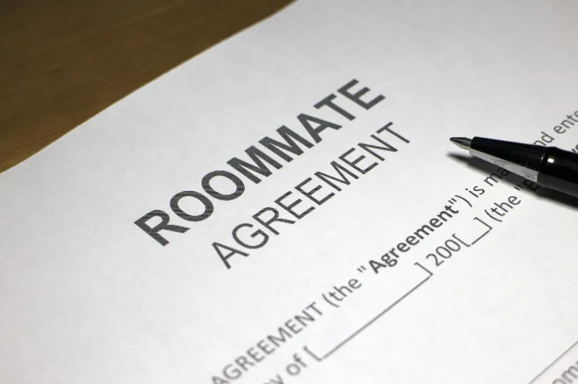A close-up of a roommate agreement with a pen, highlighting an alternative option for how to get an apartment with bad rental history.