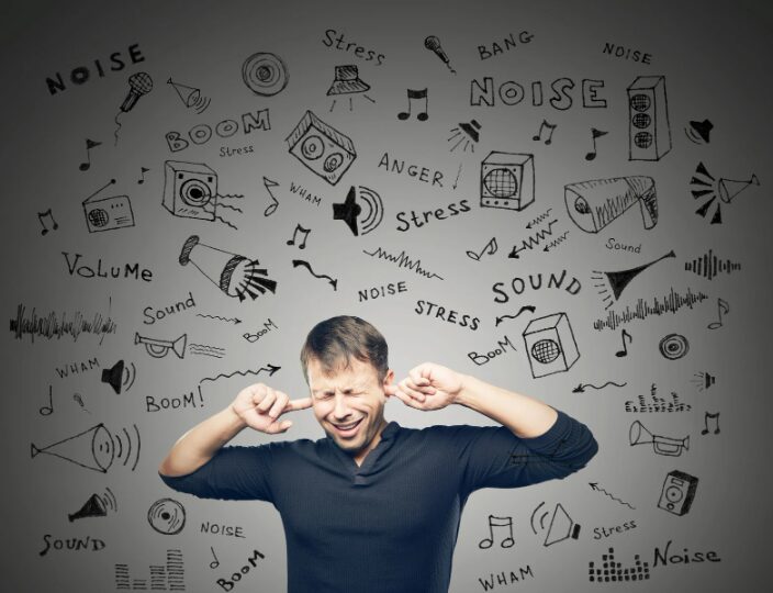 A frustrated renter covering their ears because of neighbor noise