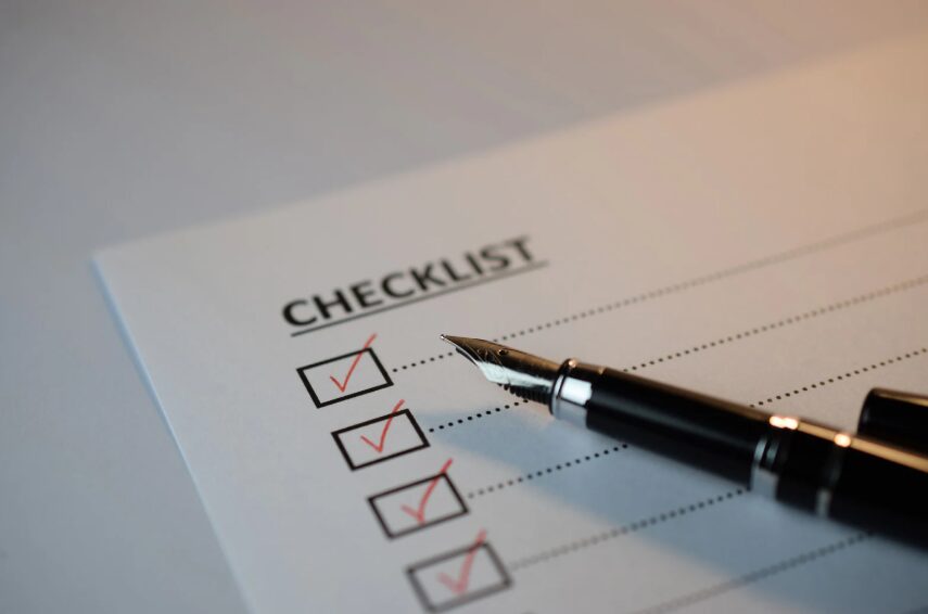 A fountain pen checking off items on a paper checklist