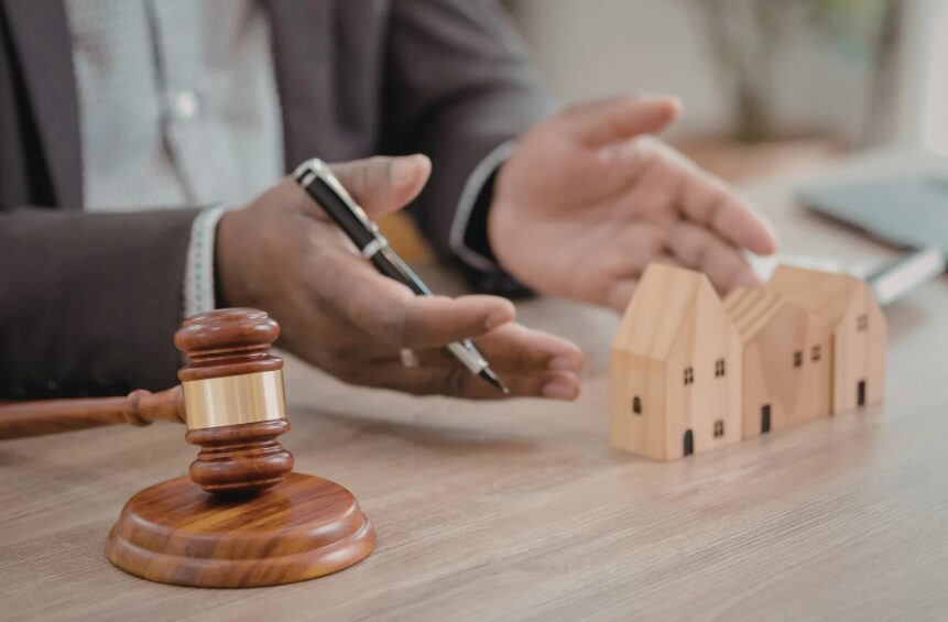 A tenant reviewing lease paperwork and photos while disputing security deposit deductions.