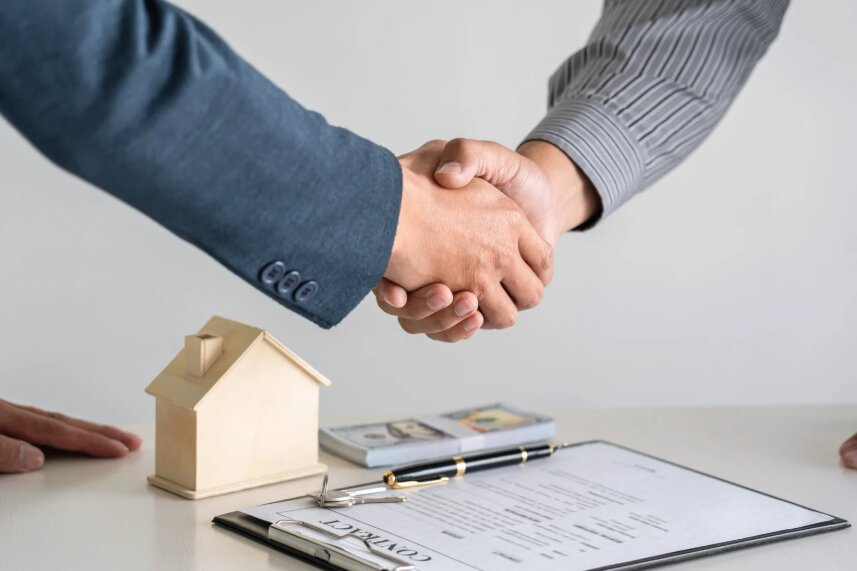 Two people reviewing an apartment application together at a kitchen table